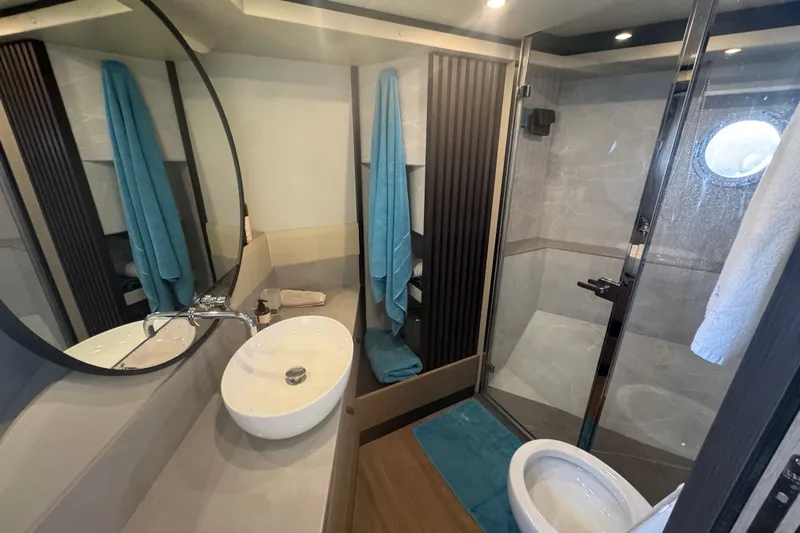  Yacht Photos Pics Luxurious bathroom in 2023 Absolute 52 FLY yacht with modern fixtures and elegant design.