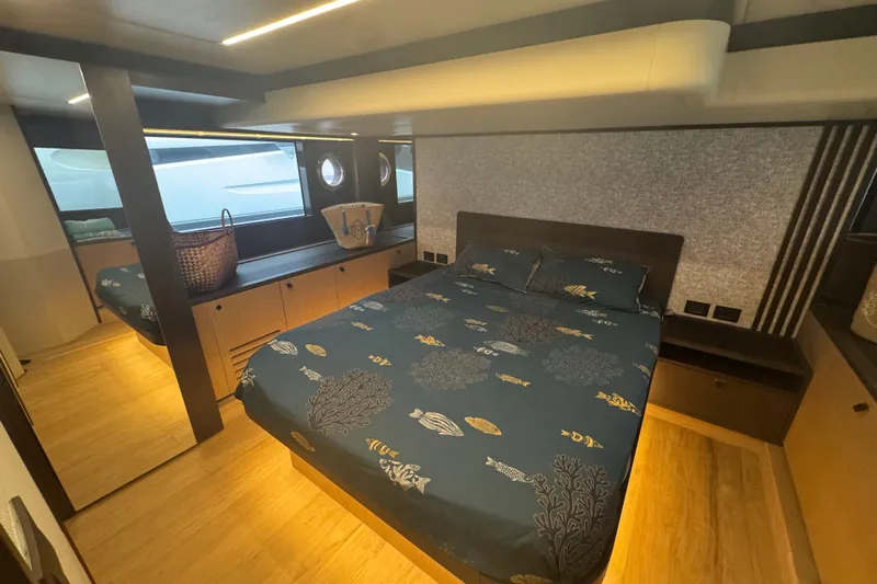  Yacht Photos Pics Luxurious bedroom interior of 2023 Absolute 52 FLY yacht with elegant bedding and modern design.