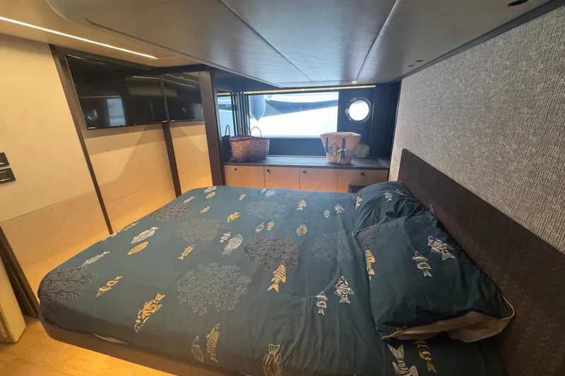  Yacht Photos Pics Luxurious bedroom interior of 2023 Absolute 52 FLY yacht with elegant bedding and window view.
