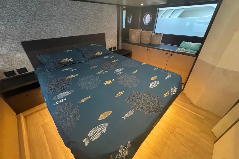  Yacht Photos Pics Luxurious bedroom interior of 2023 Absolute 52 FLY yacht with ocean-themed bedding.