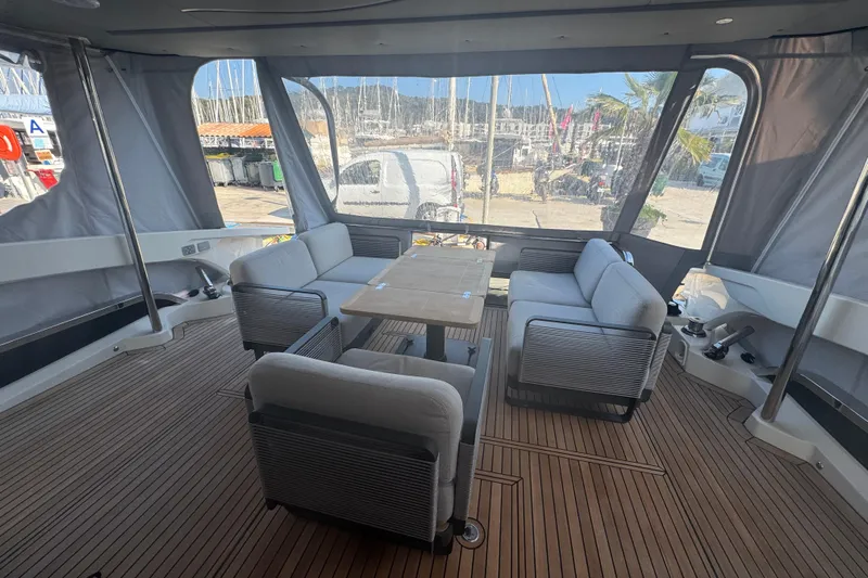  Yacht Photos Pics Luxurious interior of 2023 Absolute 52 FLY yacht with elegant seating and wooden flooring.