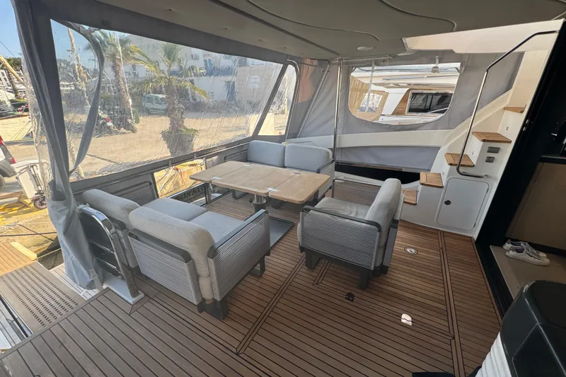  Yacht Photos Pics Luxurious 2023 Absolute 52 FLY yacht interior with elegant seating and wooden flooring.