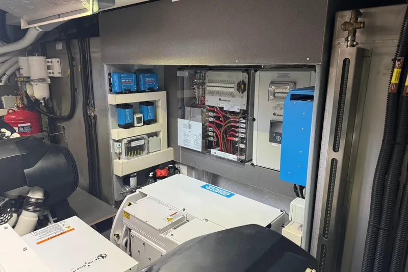  Yacht Photos Pics Engine room of 2023 Absolute 52 FLY yacht with electrical panels and equipment.