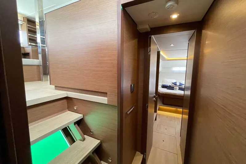Sand Dollar Yacht Photos Pics 2023 Lagoon 46 yacht interior with wooden stairs and cozy cabin view.