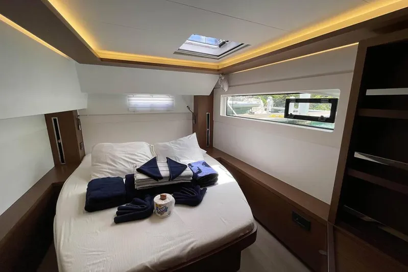 Sand Dollar Yacht Photos Pics Luxurious cabin interior of 2023 Lagoon 46 yacht with skylight and modern furnishings.