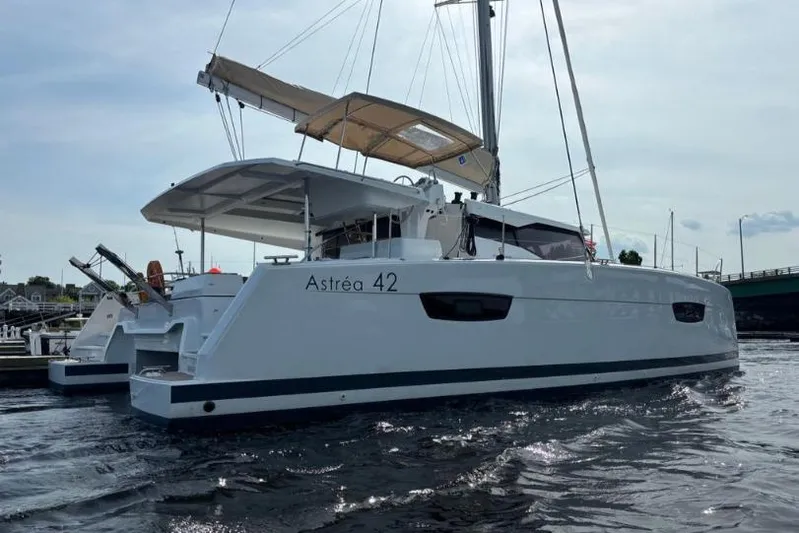 White Cap IV Yacht Photos Pics 2024 Fountaine Pajot Astrea 42 catamaran on water, showcasing sleek design and spacious deck.