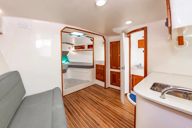Carry On Yacht Photos Pics Interior of 2003 Custom Carolina Layton Express with wood flooring and seating area.