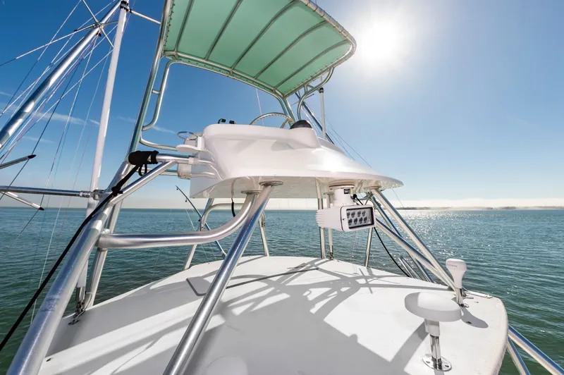 Carry On Yacht Photos Pics 2003 Custom Carolina Layton Express on open sea under bright sunshine.