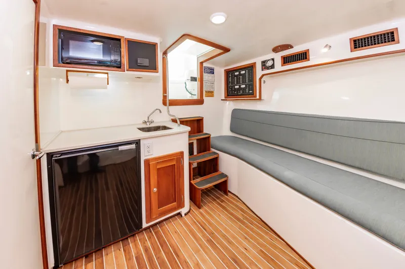 Carry On Yacht Photos Pics Interior of 2003 Custom Carolina Layton Express yacht with kitchenette and seating area.