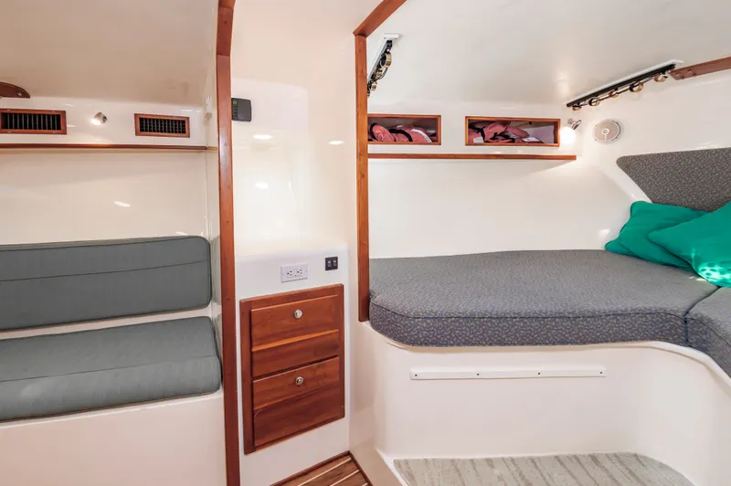 Carry On Yacht Photos Pics Interior of 2003 Custom Carolina Layton Express with seating and sleeping area.
