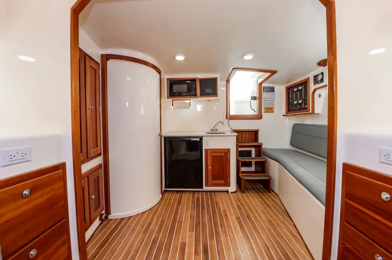 Carry On Yacht Photos Pics Interior of 2003 Custom Carolina Layton Express with wood flooring and seating area.