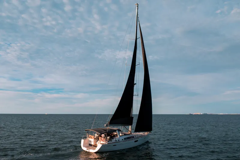  Yacht Photos Pics 2013 Beneteau Oceanis 58 sailing on open sea under a clear sky.