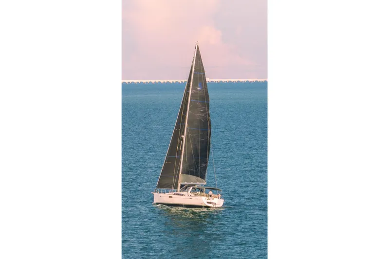  Yacht Photos Pics 2013 Beneteau Oceanis 58 sailing on calm blue waters under a clear sky.