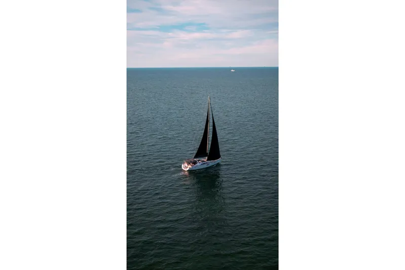  Yacht Photos Pics Sailing yacht Beneteau Oceanis 58, 2013 model, cruising on open sea under clear skies.