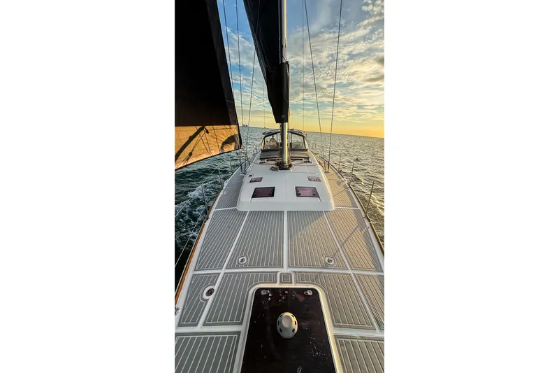  Yacht Photos Pics Sailing on a 2013 Beneteau Oceanis 58 yacht at sunset, open sea view.
