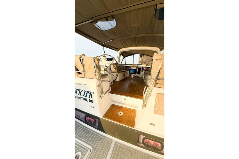  Yacht Photos Pics 2013 Beneteau Oceanis 58 yacht cockpit with teak flooring and covered seating area.