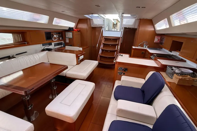  Yacht Photos Pics Luxurious interior of 2013 Beneteau Oceanis 58 yacht with elegant seating and dining area.