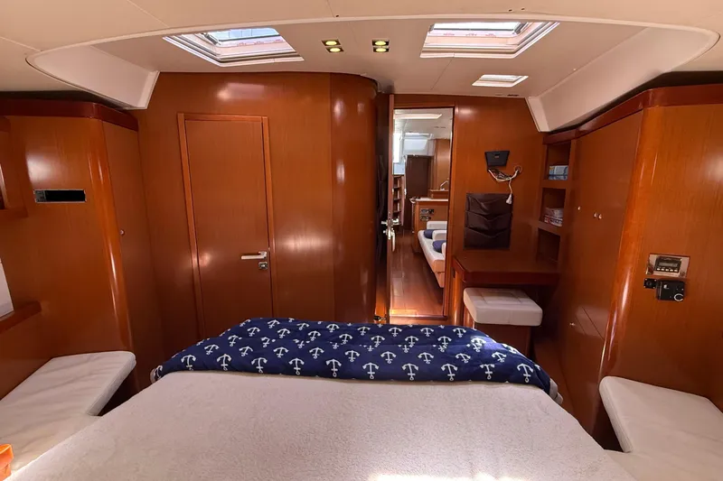  Yacht Photos Pics Luxurious interior of 2013 Beneteau Oceanis 58 yacht with wood finish and cozy bedding.