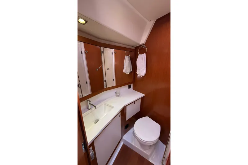  Yacht Photos Pics Bathroom interior of 2013 Beneteau Oceanis 58 yacht, featuring sink and toilet.