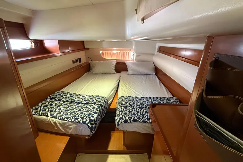  Yacht Photos Pics Interior cabin of 2013 Beneteau Oceanis 58 yacht with twin beds and wooden finish.