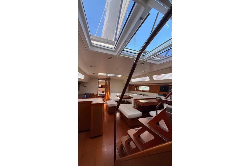  Yacht Photos Pics Interior of 2013 Beneteau Oceanis 58 yacht with skylights and wooden furnishings.