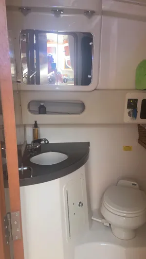  Yacht Photos Pics 2006 Grady-White 360 Express bathroom with sink, mirror, and toilet.