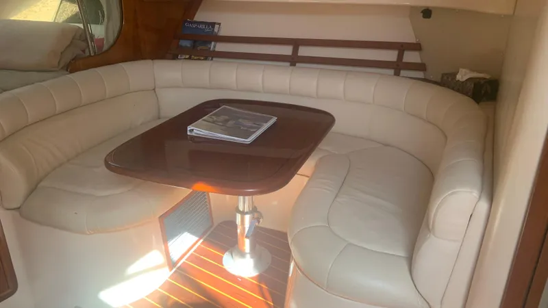  Yacht Photos Pics Interior of 2006 Grady-White 360 Express with beige seating and wooden table.