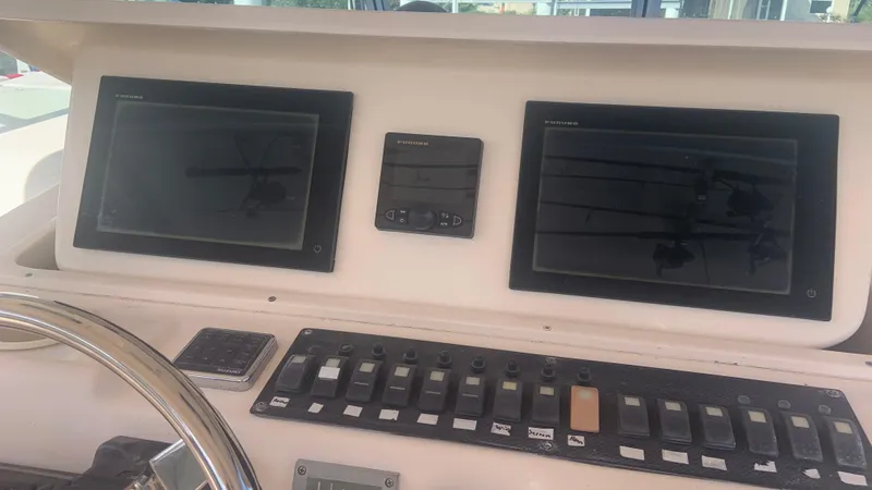 Yacht Photos Pics Control panel of 2006 Grady-White 360 Express boat with dual screens and switches.