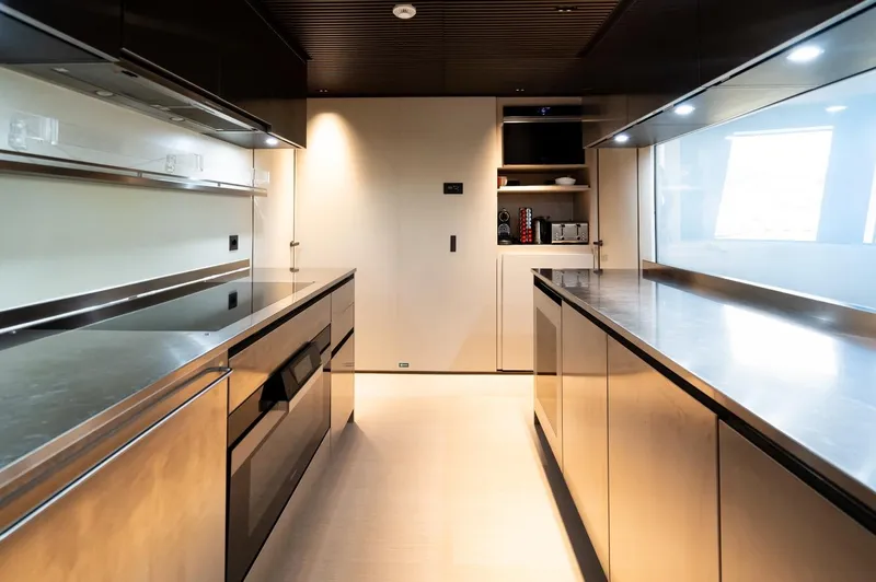 Anmax Yacht Photos Pics Modern kitchen interior on 2022 Sanlorenzo SP110 yacht, featuring sleek stainless steel surfaces.