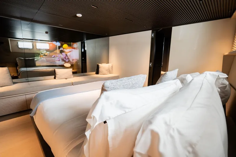 Anmax Yacht Photos Pics Luxurious bedroom interior of 2022 Sanlorenzo SP110 yacht with modern design and cozy bedding.