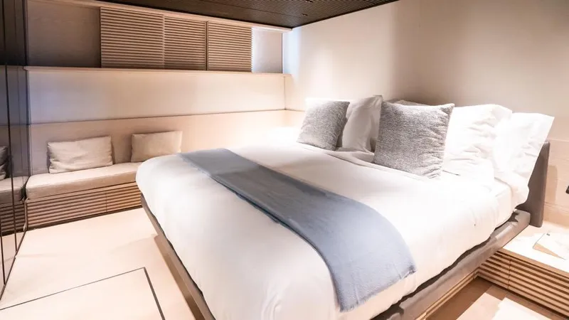 Anmax Yacht Photos Pics Luxurious bedroom interior on 2022 Sanlorenzo SP110 yacht, featuring modern design and cozy bedding.