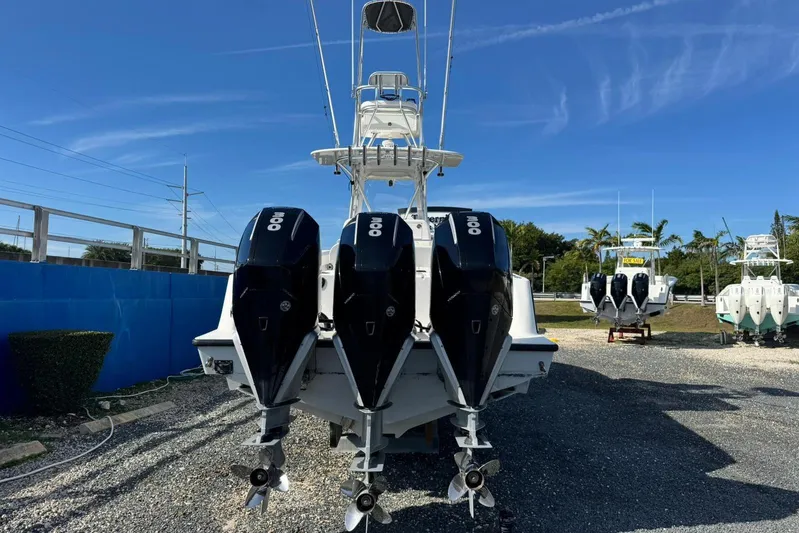  Yacht Photos Pics 2022 SeaVee 340Z boat with triple 300 horsepower engines, parked outdoors.