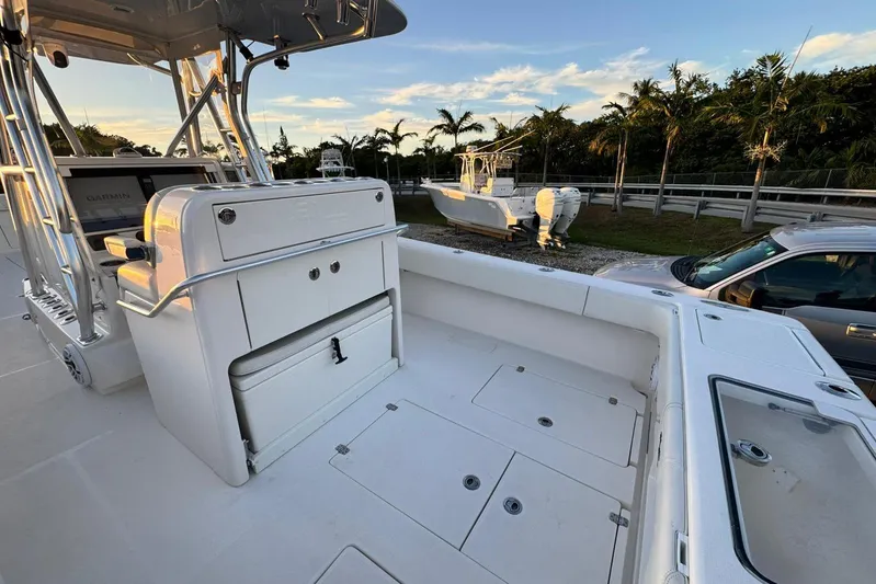  Yacht Photos Pics 2022 SeaVee 340Z boat interior with console and storage, parked near palm trees.