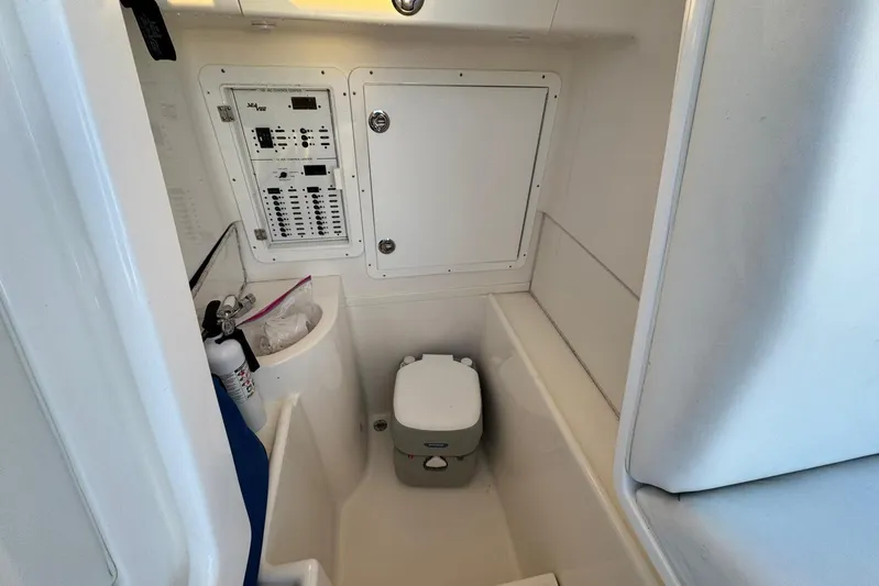  Yacht Photos Pics 2022 SeaVee 340Z boat interior with compact bathroom and control panel.