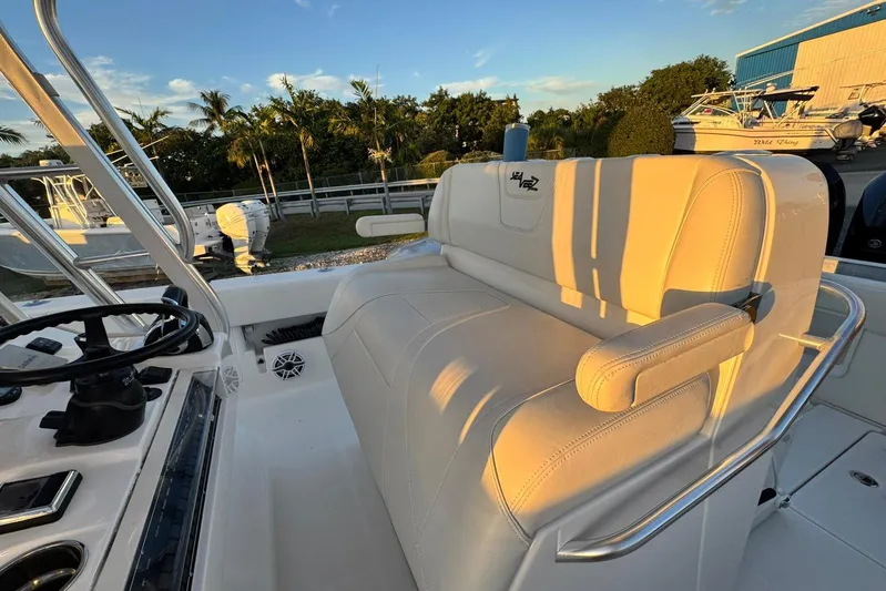  Yacht Photos Pics 2022 SeaVee 340Z boat interior with white seating and steering wheel, under a clear sky.