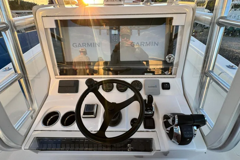  Yacht Photos Pics 2022 SeaVee 340Z boat console with Garmin navigation system and steering wheel.