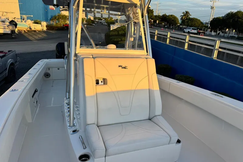  Yacht Photos Pics 2022 SeaVee 340Z boat interior with seating and console, docked outdoors.