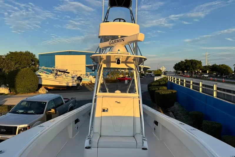  Yacht Photos Pics 2022 SeaVee 340Z boat with Garmin equipment, parked near a blue building.