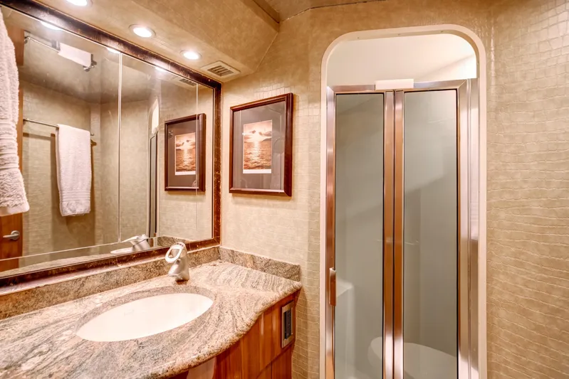 Mobster Yacht Photos Pics Luxurious bathroom in 2007 Viking 68 Convertible yacht with elegant fixtures and modern design.