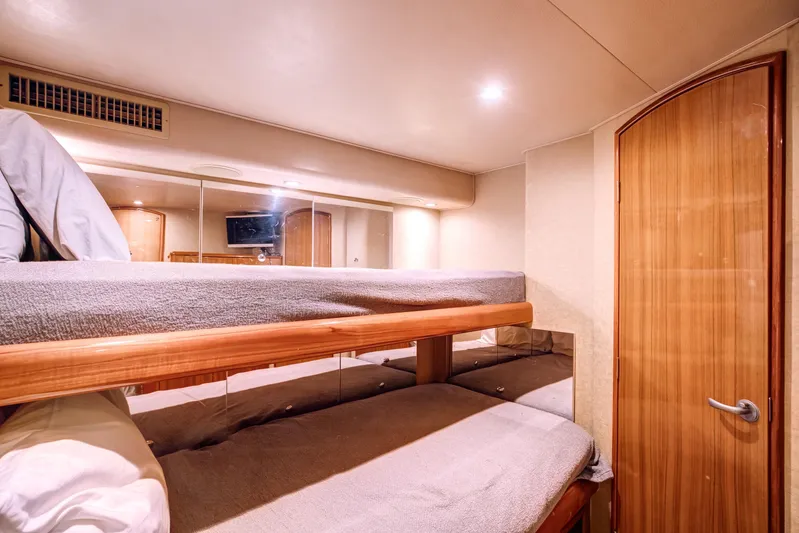 Mobster Yacht Photos Pics Interior of 2007 Viking 68 Convertible yacht with cozy bunk beds and wooden door.
