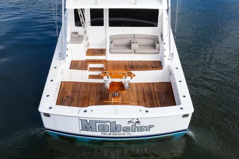 Mobster Yacht Photos Pics 2007 Viking 68 Convertible yacht with teak deck, docked in calm waters.