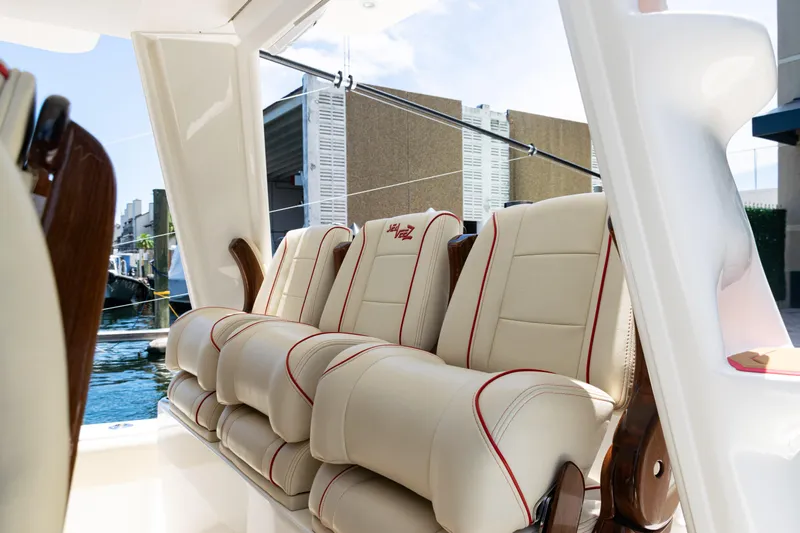  Yacht Photos Pics Luxurious seating on 2022 SeaVee 450z boat, featuring cream upholstery with red accents.