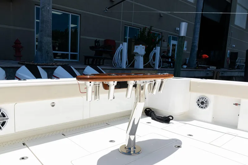  Yacht Photos Pics 2022 SeaVee 450z boat deck with rod holders and speakers in a marina setting.