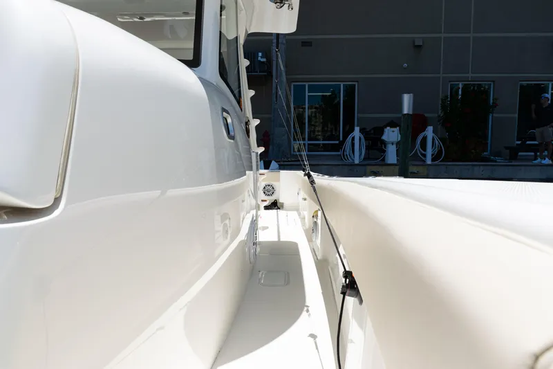  Yacht Photos Pics 2022 SeaVee 450z boat side view at dock, showcasing sleek design.