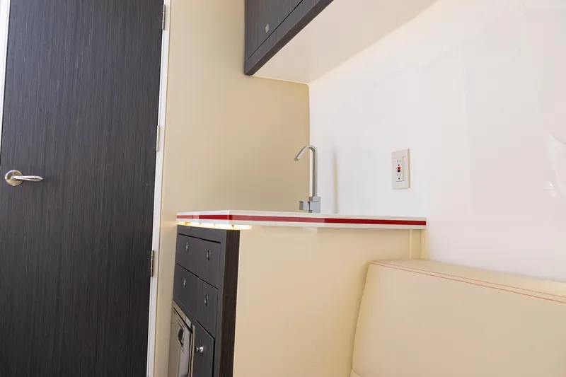  Yacht Photos Pics Interior of 2022 SeaVee 450z boat featuring a compact kitchenette and seating area.