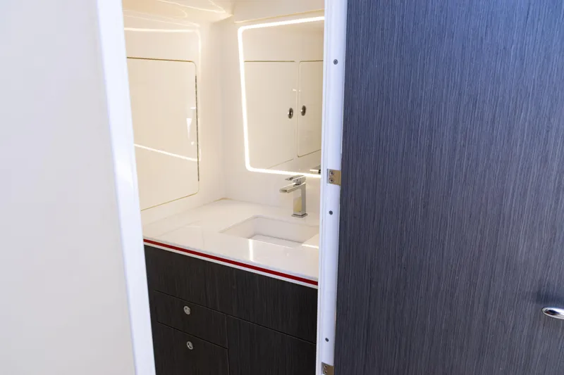  Yacht Photos Pics 2022 SeaVee 450z bathroom interior with modern sink and sleek cabinetry.
