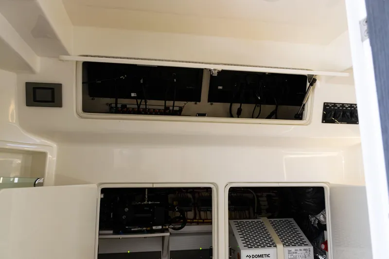 Yacht Photos Pics 2022 SeaVee 450z interior electronics compartment with open panels and visible wiring.