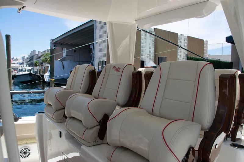  Yacht Photos Pics Luxurious seating on a 2022 SeaVee 450z boat, docked at a marina.