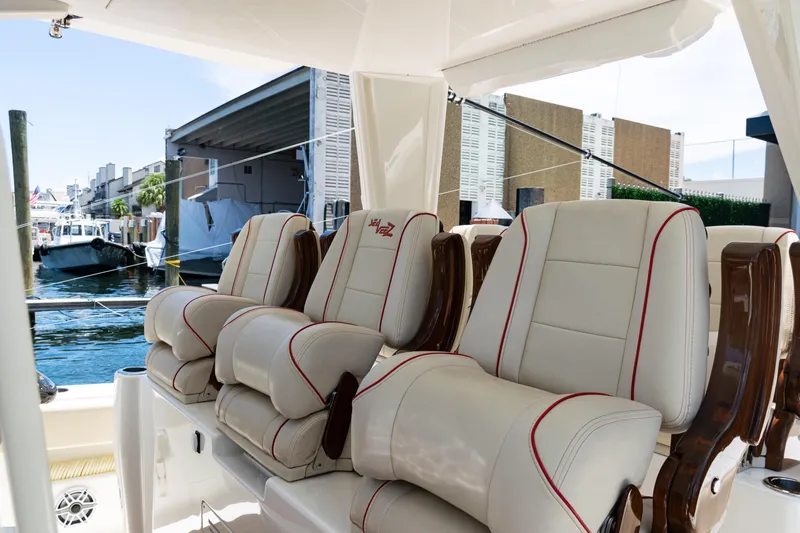  Yacht Photos Pics Luxurious seating on 2022 SeaVee 450z boat, docked in a marina setting.