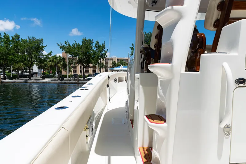  Yacht Photos Pics 2022 SeaVee 450z boat deck with sleek design, docked by a waterfront.